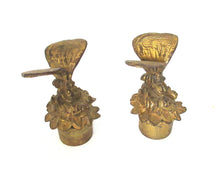 Antique brass candle snuffer with butterfly.