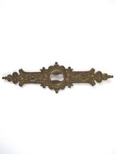 UpperDutch:Keyhole cover,1 (one) Stamped Escutcheon, Antique Brass Ornate Keyhole cover / plate.