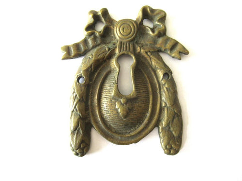 Escutcheon, bow, keyhole cover, Restoration hardware.