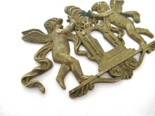 Antique Brass keyhole cover, ornament, embellishment, putti, cherub, angel.