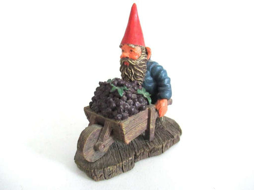 UpperDutch:,Designed by Rien Poortvliet. Gnome figurine transporting grapes with a wheelbarrow 'Christian'. Classic gnomes series.