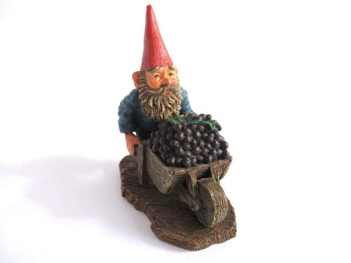 UpperDutch:Gnome,Gnome figurine 'Christian' transporting grapes with a wheelbarrow. Classic gnomes series after a design by Rien Poortvliet.