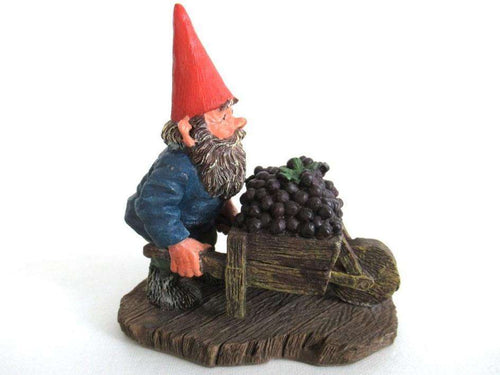 UpperDutch:,Gnome figurine transporting grapes with a wheelbarrow 'Christian'. Classic gnomes series after a design by Rien Poortvliet.