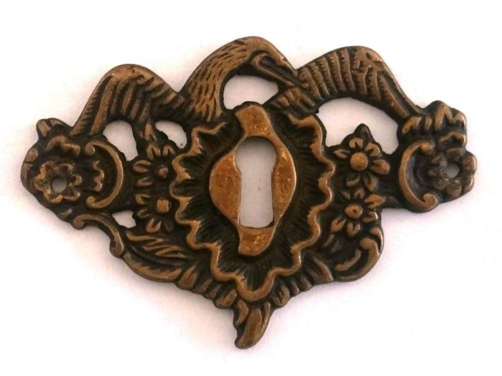 UpperDutch:Hooks and Hardware,1 Antique solid brass bird keyhole frame, Antique ornate floral key hole plate. Escutcheon with flowers and a large bird wings.