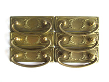 UpperDutch:Hooks and Hardware,1 (ONE) Old cabinet pull escutcheon with laurel design. NOS Brass Antique Drawer Handle with hanging pull. Restoration hardware.