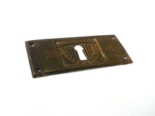 UpperDutch:Hooks and Hardware,Stamped Art deco Escutcheon, Distressed Floral Brass, Copper Keyhole cover with flowers.