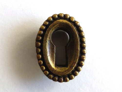 UpperDutch:Hooks and Hardware,1 Vintage small oval keyhole cover. Cast brass escutcheon for jewelry making, furniture decoration. Distressed hardware.
