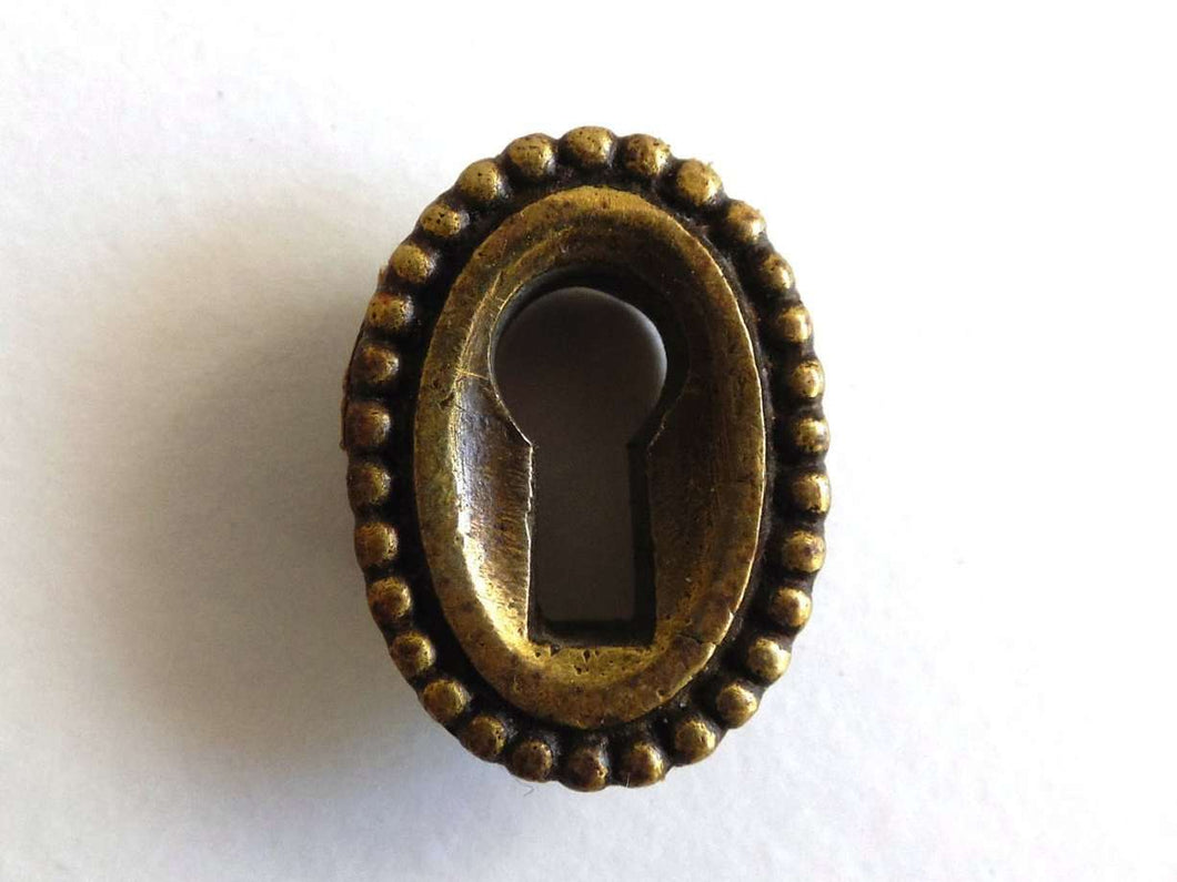 UpperDutch:Hooks and Hardware,1 Vintage small oval keyhole cover. Cast brass escutcheon for jewelry making, furniture decoration. Distressed hardware.