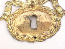 UpperDutch:,1 (ONE) French Keyhole cover, Empire Solid brass large Key Hole Frame. Oval leaf and bow shape. Restoration hardware.