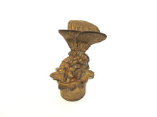 Antique brass candle snuffer with butterfly.