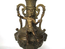 UpperDutch:Candelabras,Set of 2 ornate antique brass putti candlestick holders.