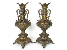 UpperDutch:Candelabras,Set of 2 ornate antique brass putti candlestick holders.