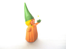 Brb Gnome holding candle after a design by Rien Poortvliet, Lisa the Gnome. Orange Pajamas
