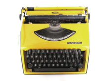 UpperDutch:Typewriter,Mustard Yellow Triumph Tippa made in 1977, QWERTY layout. Fully functional typewriter, vintage. Mustard yellow retro office decor.