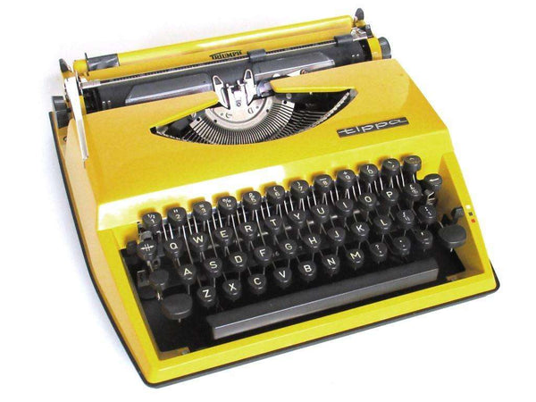 UpperDutch:Typewriter,Mustard Yellow Triumph Tippa made in 1977, QWERTY layout. Fully functional typewriter, vintage. Mustard yellow retro office decor.