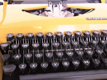UpperDutch:Typewriter,Mustard Yellow Triumph Tippa made in 1977, QWERTY layout. Fully functional typewriter, vintage. Mustard yellow retro office decor.