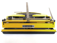 UpperDutch:Typewriter,Mustard Yellow Triumph Tippa made in 1977, QWERTY layout. Fully functional typewriter, vintage. Mustard yellow retro office decor.