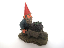 'Christian' Gnome figurine transporting grapes with a wheelbarrow.  Classic gnomes series after a design by Rien Poortvliet.