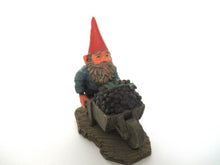 'Christian' Gnome figurine transporting grapes with a wheelbarrow.  Classic gnomes series after a design by Rien Poortvliet.