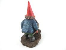 Gnome figurine transporting grapes with a wheelbarrow.  'Christian' Classic gnomes series after a design by Rien Poortvliet.