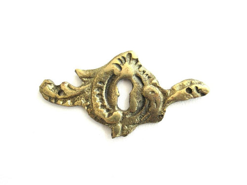 Antique brass keyhole cover. Ornamental escutcheon, cabinet hardware, furniture applique.