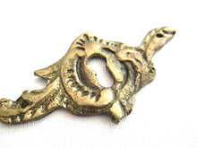Antique brass keyhole cover. Ornamental escutcheon, cabinet hardware, furniture applique.