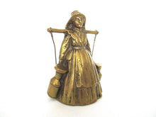 Vintage brass table bell, woman with milk jugs.
