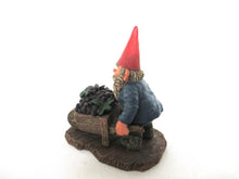 Classic Gnomes 'Christian' after a design by Rien Poortvliet. Gnome figurine transporting grapes with a wheelbarrow.