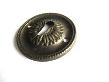 Vintage Thin Pressed Keyhole cover, floral design.