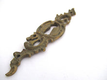 1 (ONE) Antique ornate brass keyhole cover. Ornamental escutcheon, cabinet hardware, furniture applique.