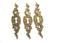 1 (ONE) Antique ornate brass keyhole cover. Ornamental escutcheon, cabinet hardware, furniture applique.