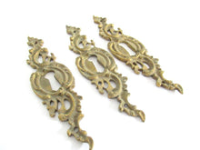 1 (ONE) Antique ornate brass keyhole cover. Ornamental escutcheon, cabinet hardware, furniture applique.
