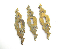 1 (ONE) Antique ornate brass keyhole cover. Ornamental escutcheon, cabinet hardware, furniture applique.