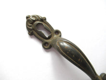 Cabinet Pull including keyhole cover, escutcheon.