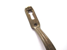 Authentic vintage cabinet handle including keyhole cover, escutcheon.