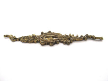 Ornate brass escutcheon, cabinet hardware, furniture applique.