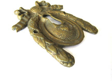 Escutcheon, bow, keyhole cover, Restoration hardware.