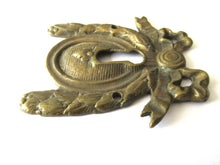 Escutcheon, bow, keyhole cover, Restoration hardware.