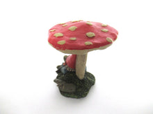 Gnome sleeping under a mushroom. 'Slumber Chief' a design by Rien Poortvliet.