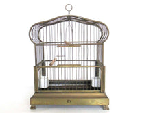 UpperDutch:,Antique German Bird Cage with porcelain feeders and glass panels on both sides.