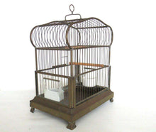UpperDutch:,Antique German Bird Cage with porcelain feeders and glass panels on both sides.