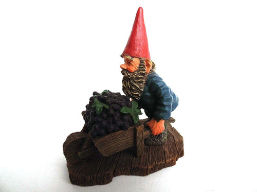 UpperDutch:Gnome,'Christian' Gnome figurine transporting grapes with a wheelbarrow.  Classic gnomes series after a design by Rien Poortvliet.