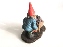 UpperDutch:,Classic Gnomes 'Christian' after a design by Rien Poortvliet. Gnome figurine transporting grapes with a wheelbarrow.