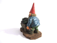 UpperDutch:Gnome,Gnome figurine 'Christian' transporting grapes with a wheelbarrow.  Classic gnomes series after a design by Rien Poortvliet.
