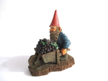 UpperDutch:Gnome,Gnome figurine 'Christian' transporting grapes with a wheelbarrow.  Classic gnomes series after a design by Rien Poortvliet.