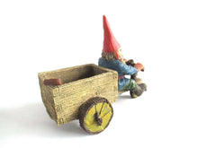 UpperDutch:,Gnome 'Thomas' riding a cargo bike with shovel. Gnome figurine after a design by Rien Poortvliet. Classic Gnomes series. AAAAAAA International Co. Ltd.