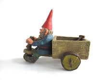 UpperDutch:,Gnome 'Thomas' riding a cargo bike with shovel. Gnome figurine after a design by Rien Poortvliet. Classic Gnomes series. AAAAAAA International Co. Ltd.