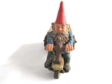 UpperDutch:,Gnome 'Thomas' riding a cargo bike with shovel. Gnome figurine after a design by Rien Poortvliet. Classic Gnomes series. AAAAAAA International Co. Ltd.