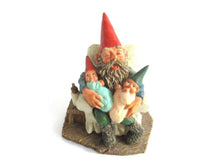UpperDutch:Gnome,Gnome with grandchildren sitting in a chair figurine. 'Grandfather with Children' Part of the Classic Gnomes series designed by Rien Poortvliet