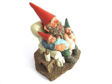UpperDutch:Gnome,Gnome with grandchildren sitting in a chair figurine. 'Grandfather with Children' Part of the Classic Gnomes series designed by Rien Poortvliet